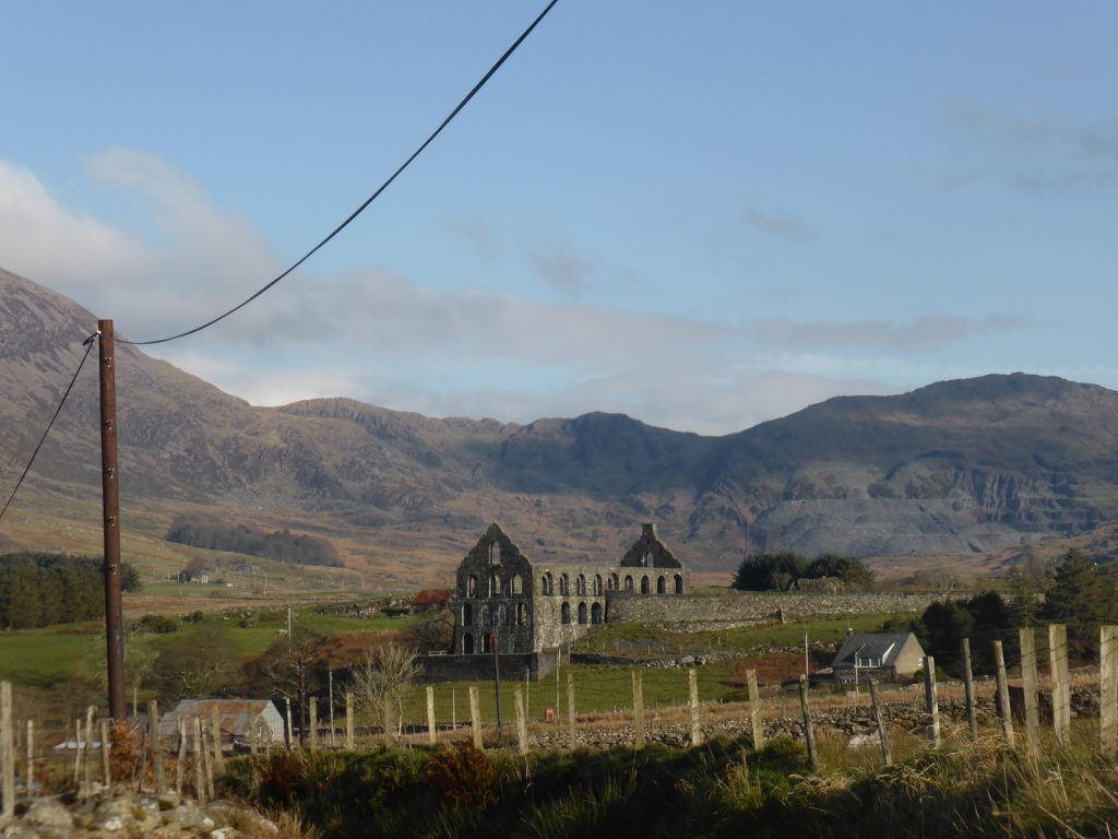 ruined mill and hills behind
