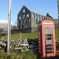 red phonebox and ruined mill