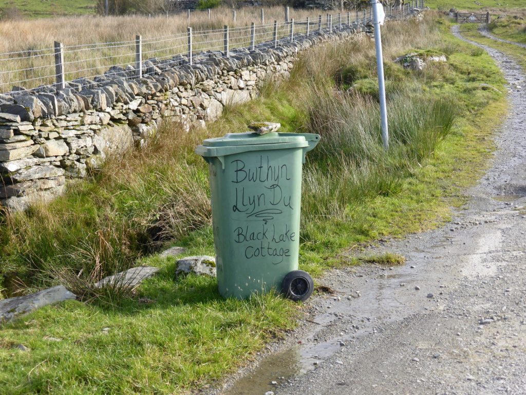 wheelie bin labelled with nice curly lettering