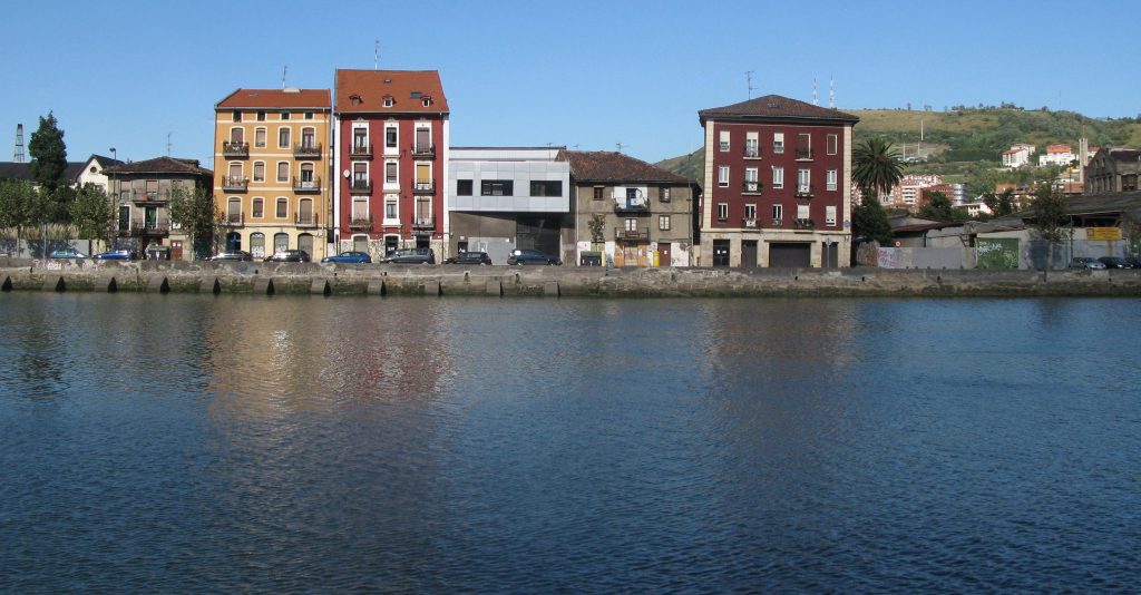 buildings lining deep blue river