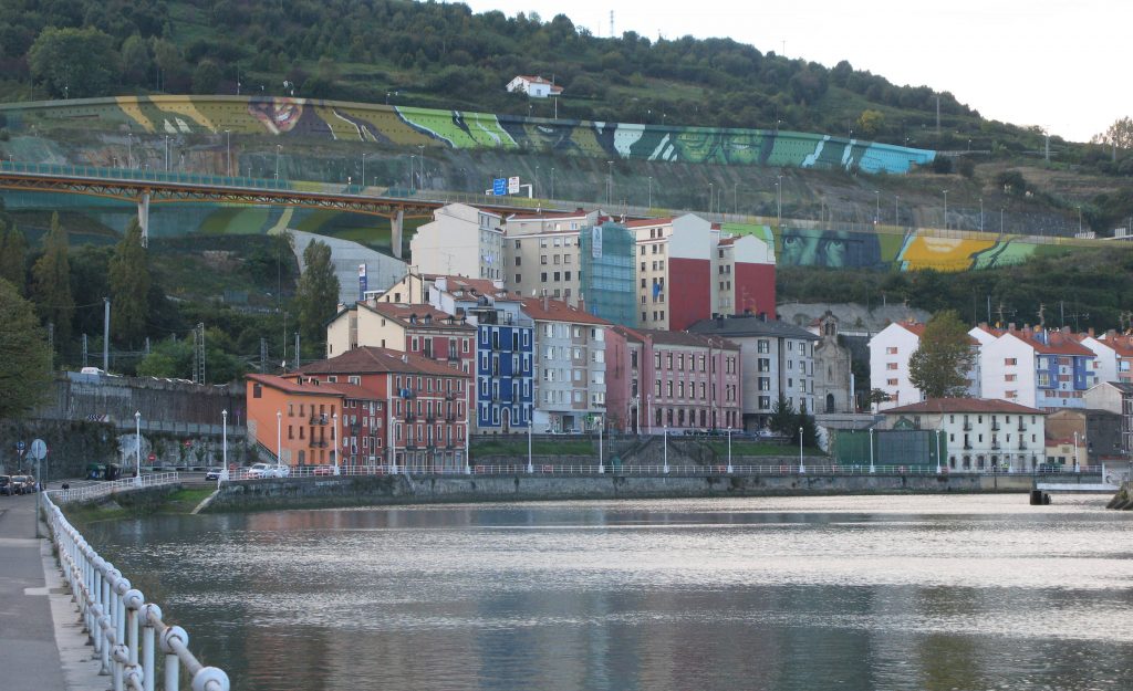 view along river - coloured buildings and painted concrete