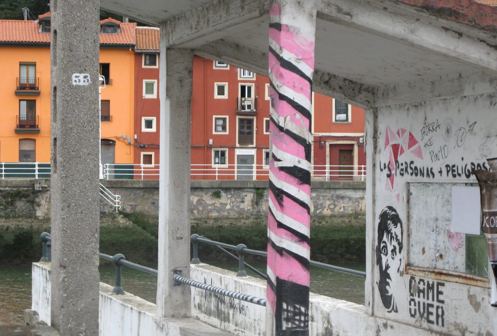 pink stripey painted bus stop pillar