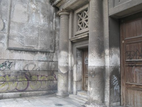 stone building with faded scribbling