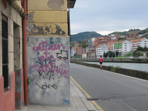 scribbled wall and jogger
