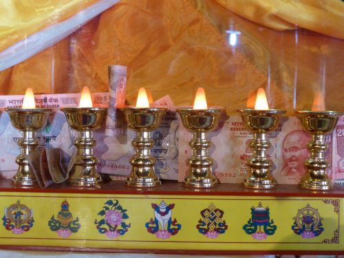 neat row of butterlamps on altar