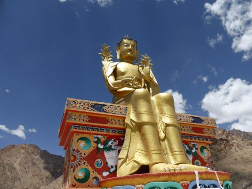 golden buddha on painted throne