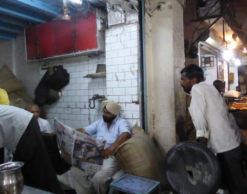stallholders discussing newspaper article