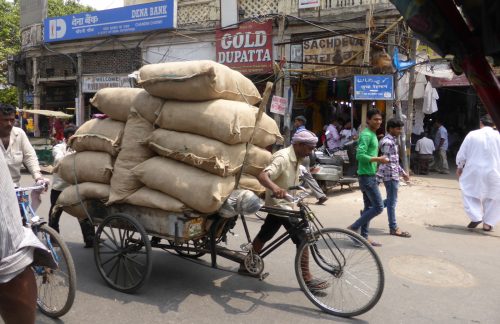 sacks piled up on delivery bike cart