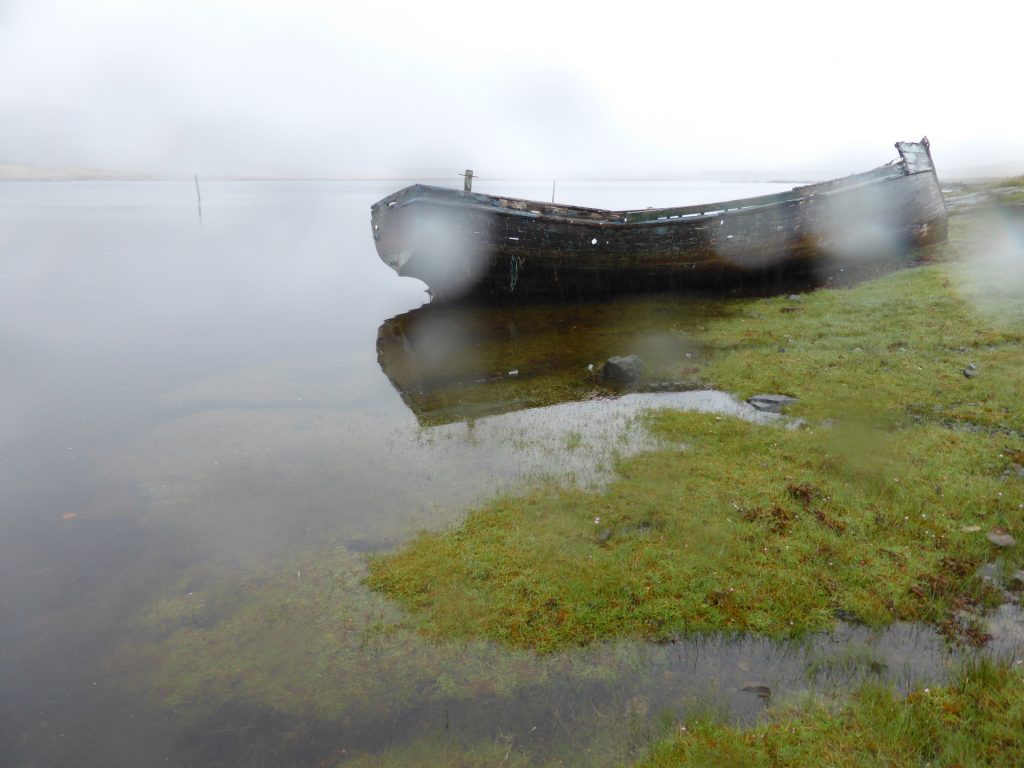 boat and saltmarsh in rain