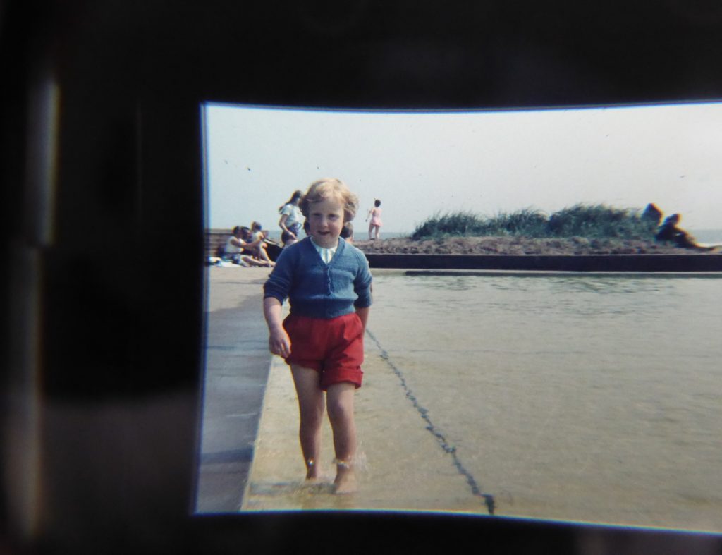 small girl in beach paddling pool