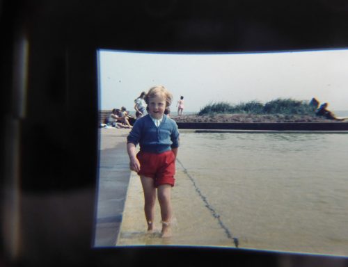 small girl in beach paddling pool