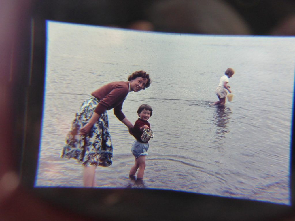 woman in flowery dirndl with small girls in sea