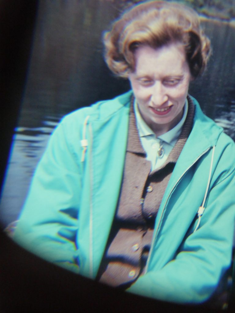 red haired woman in blue anorak, smiling