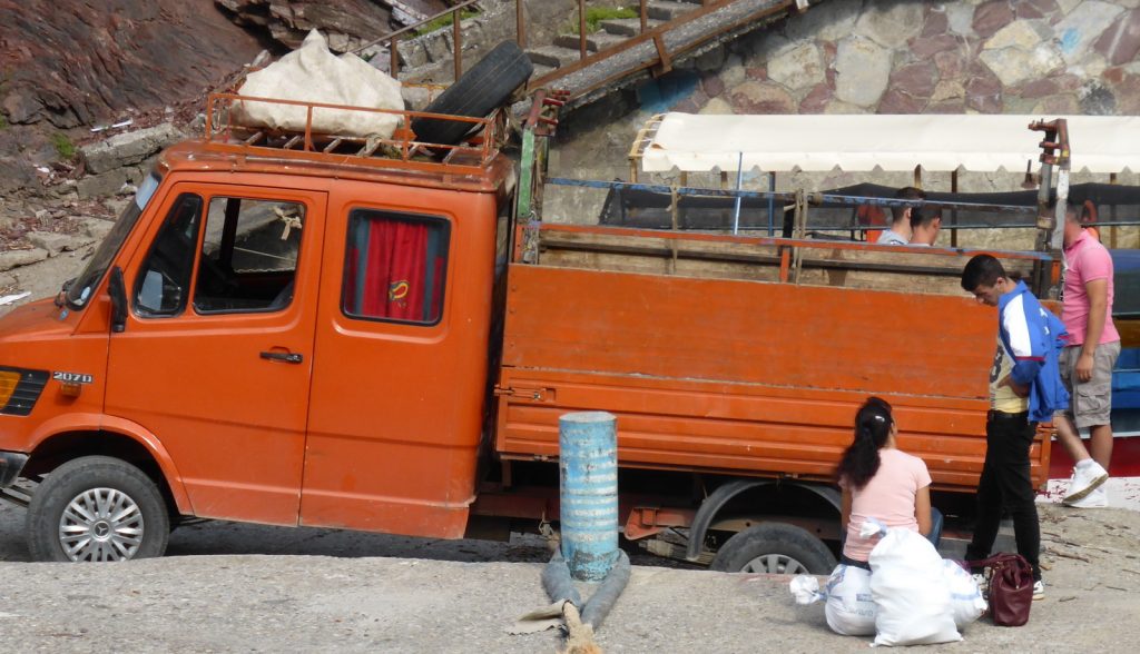 people waiting with orange truck