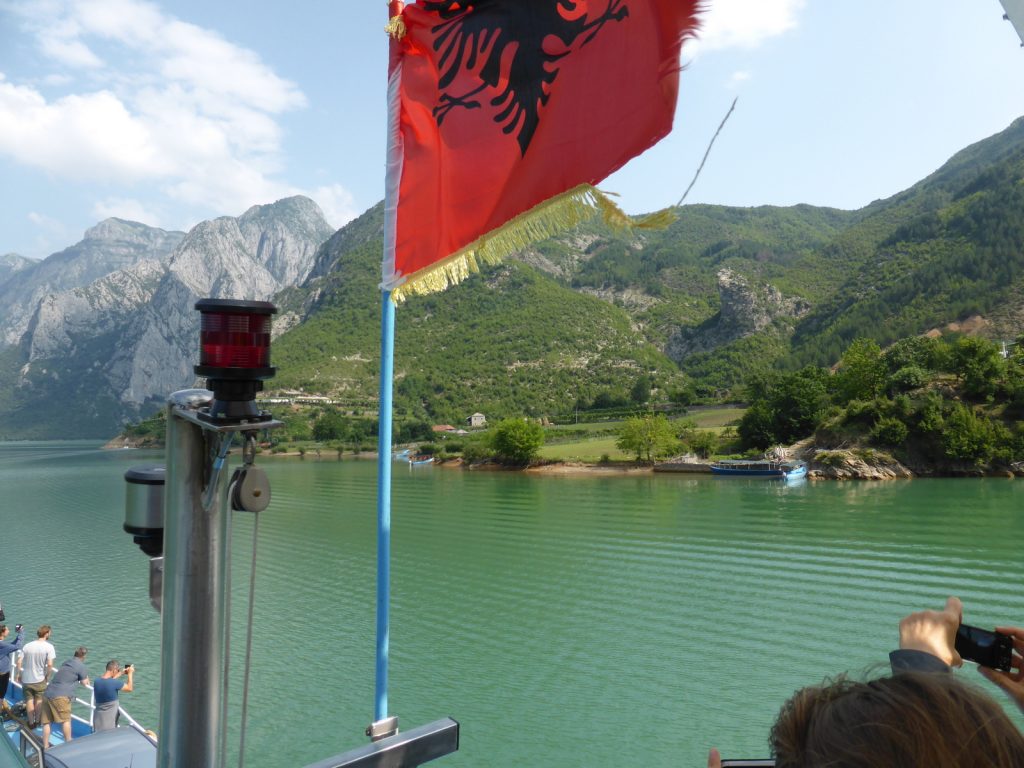 red flag against deep green lake