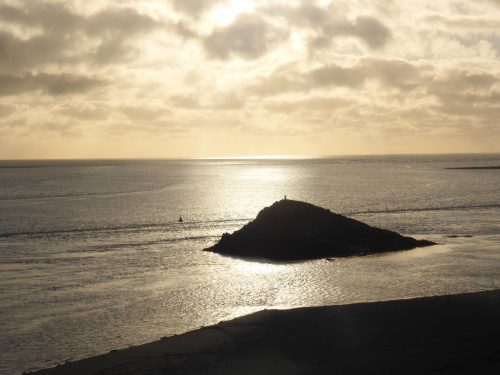 silver sea, black rock and beach
