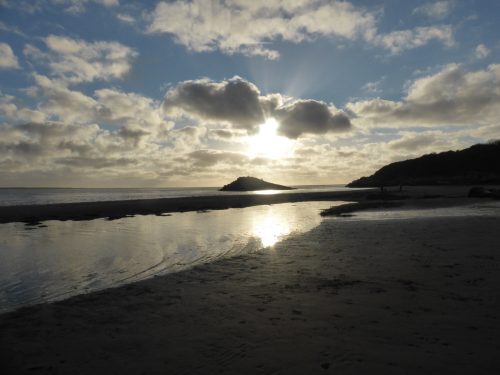 on the beach looking into the sun