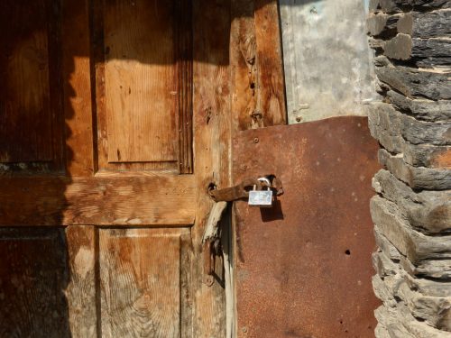 old door new shiny padlock