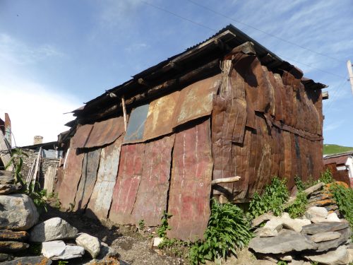 battered metal sheets clad shed