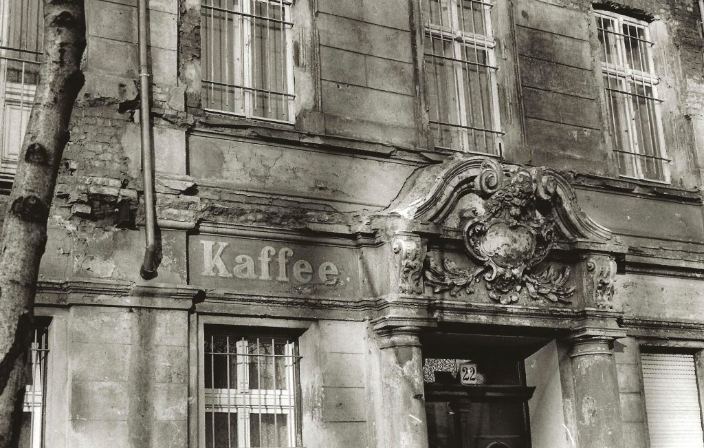 Kaffee hand-painted sign and ornate door lintel