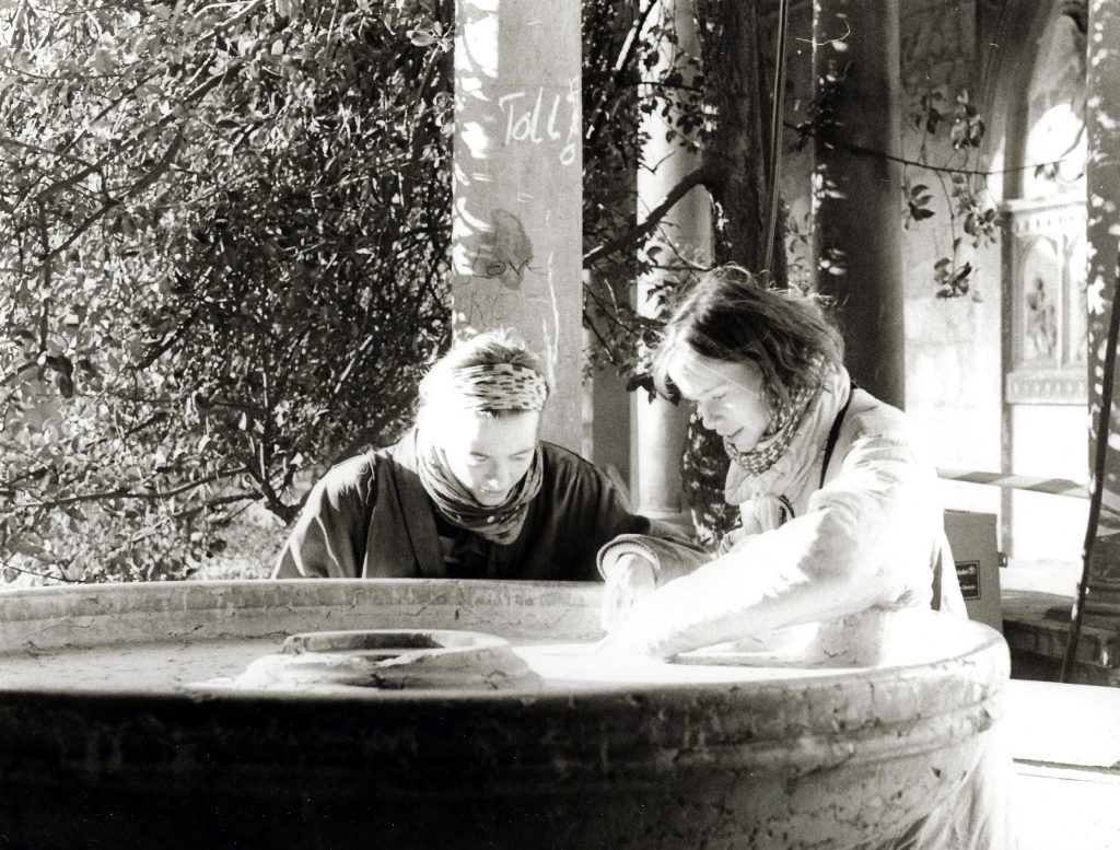 sisters looking at something intently, in stone fountain