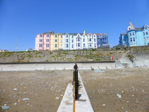 pastel coloured houses above beach