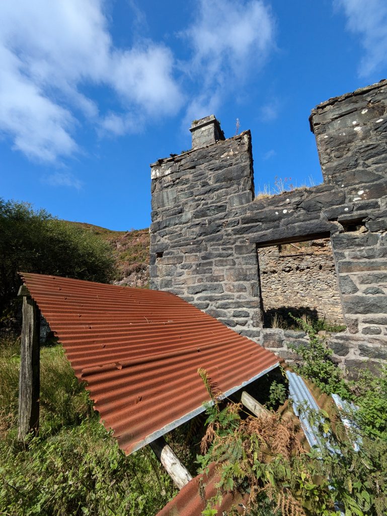 stone chimney and corrugated iron sheet