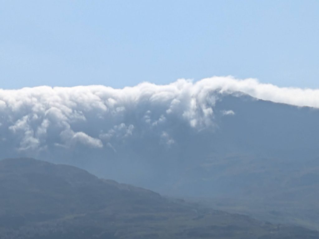 cloud rolling over ridgeline