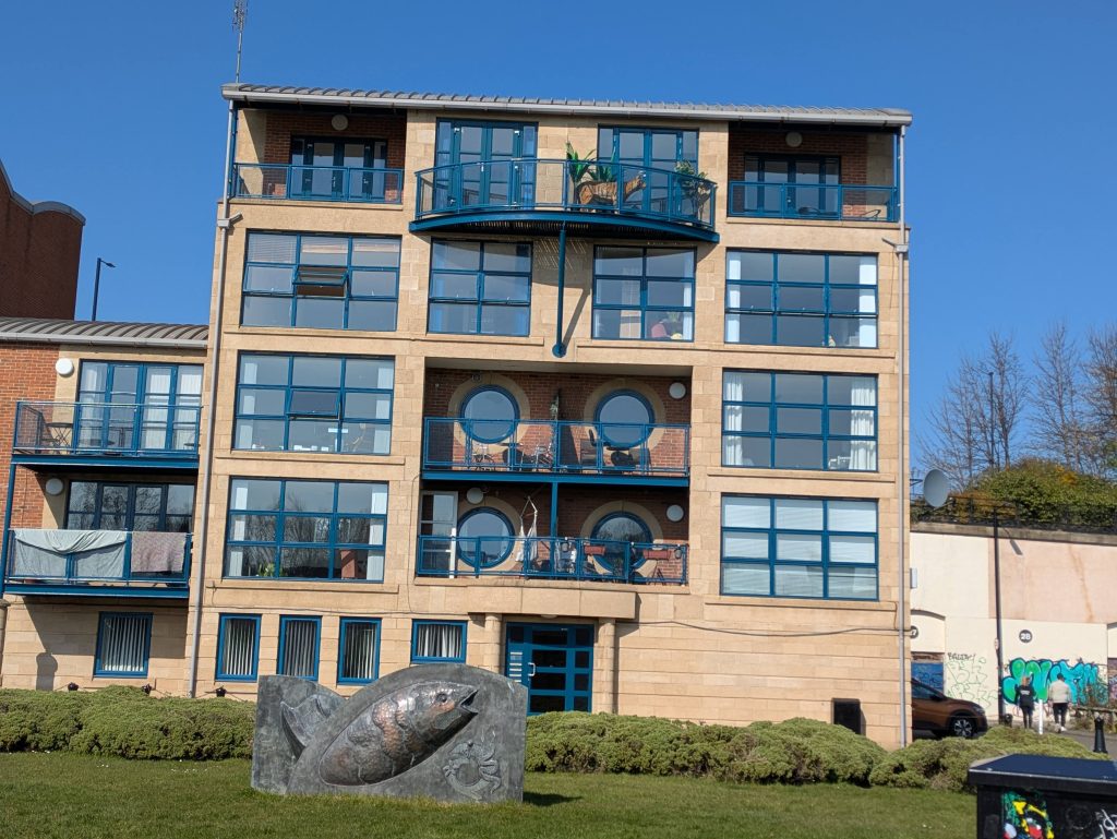 apartments - tiger on the balcony, fish sculpture on the grass out front